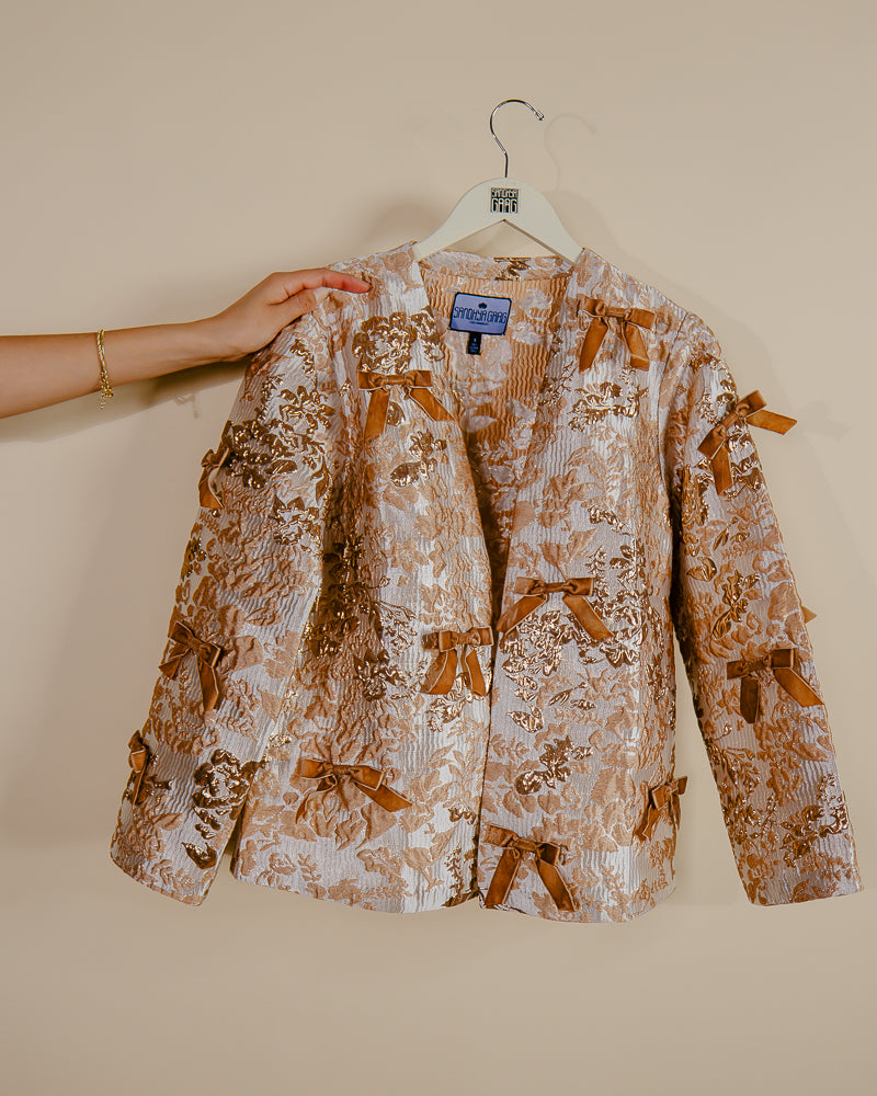 Sandhya Garg Agra gold jacquard jacket for women styled for Indian fusion or South Asian occasion — loose fit and velvet bows visible
